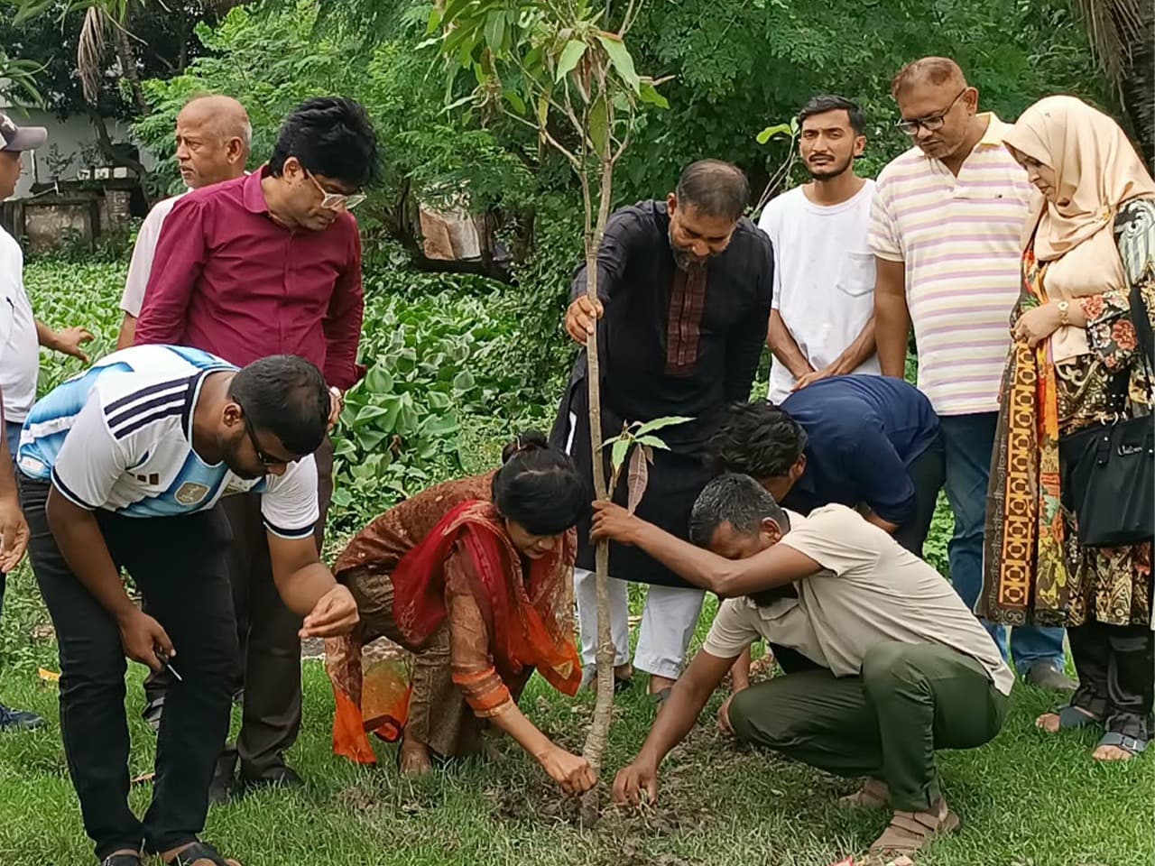 ItaLearn team members, school principals, and honorable guest Tutul Chowdhury participating in a tree plantation program at a school in Khulna.